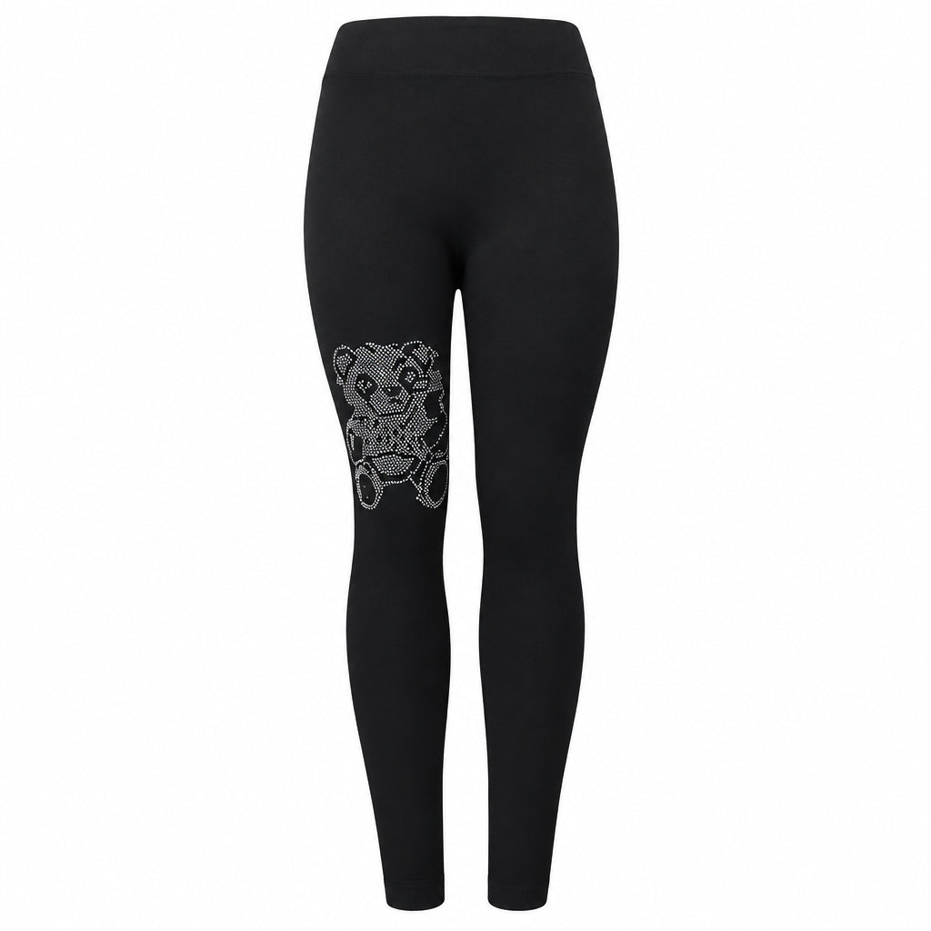 A pair of black leggings with decorative white patterns on the lower left leg.