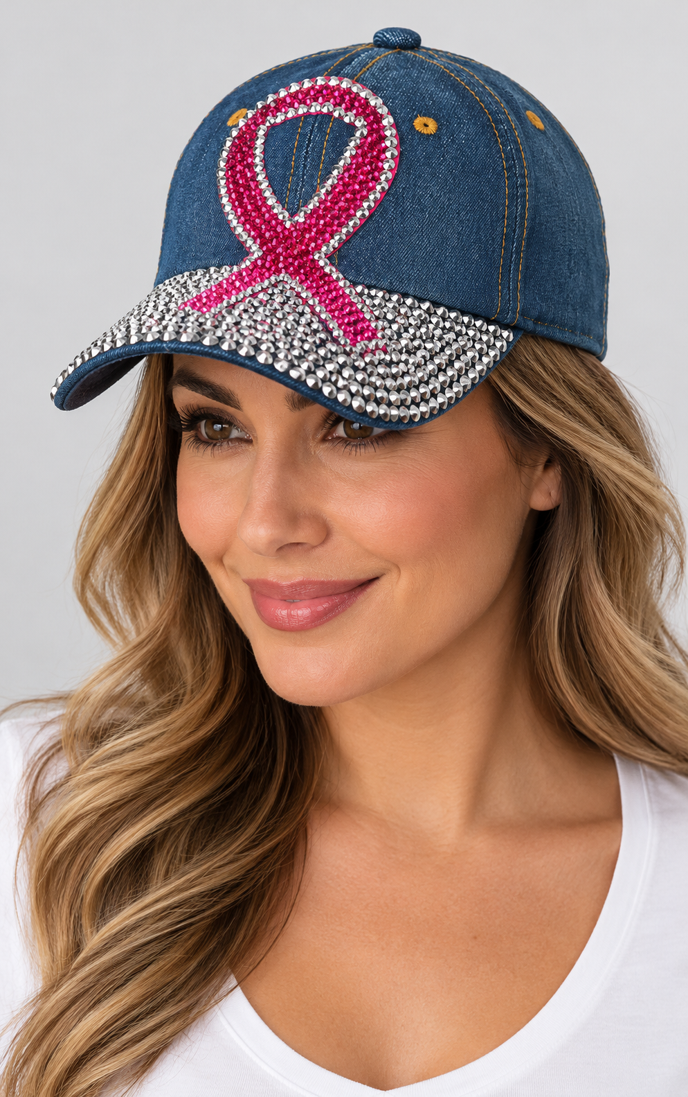 Human model wearing Denim Baseball Cap: CA030 Breast Cancer Awareness Denim & Pink Stone