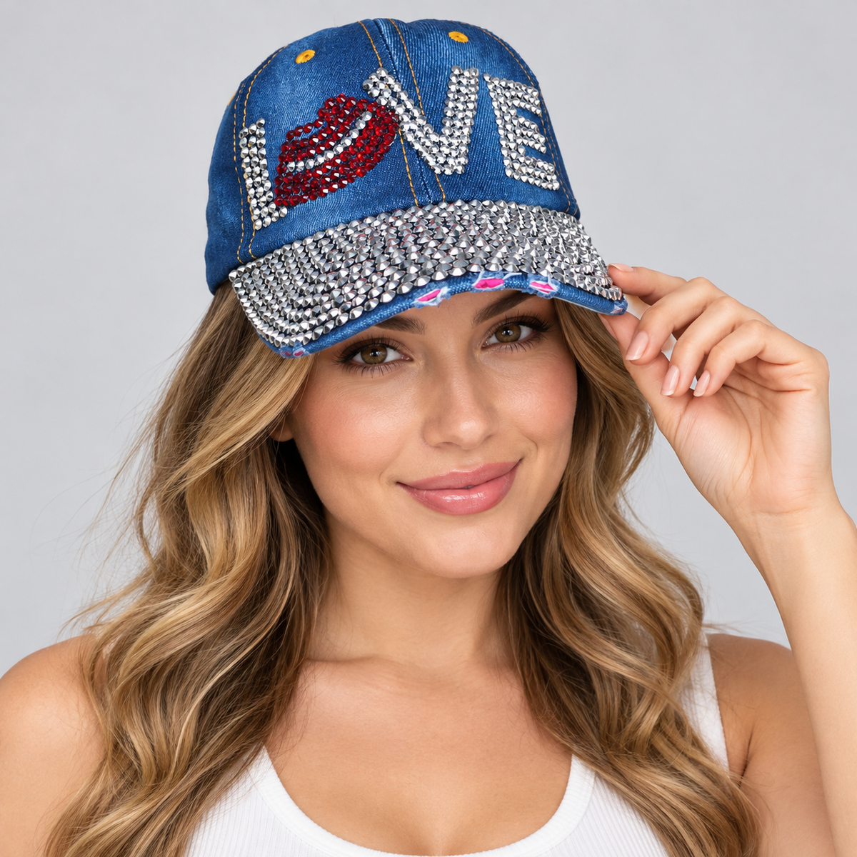 Human model wearing Denim Baseball Cap: CA14229 "LOVE" Rhinestone Studded Hat in denim